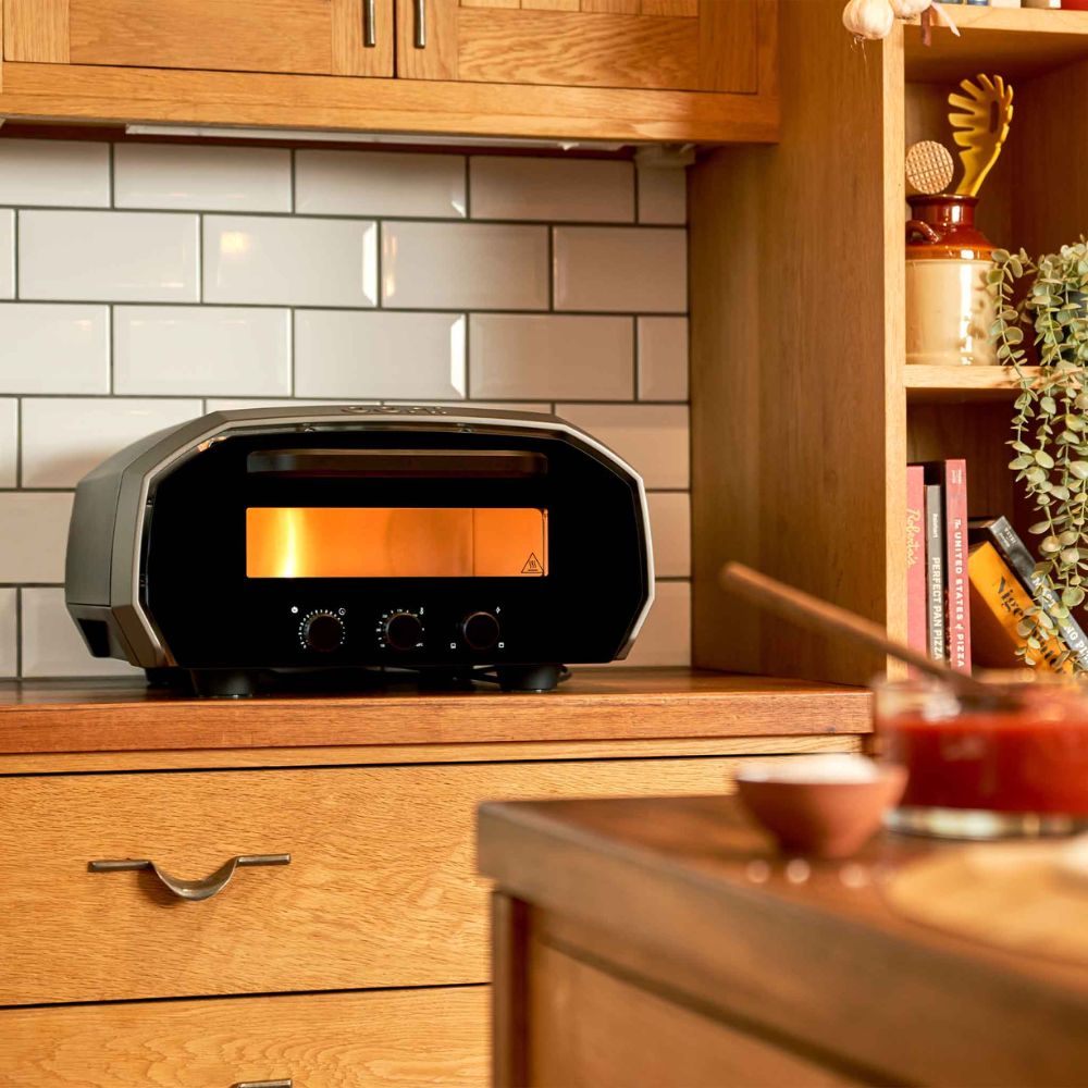 KL35591 Ooni Volt Electric Pizza Oven on Kitchen Bench illuminated