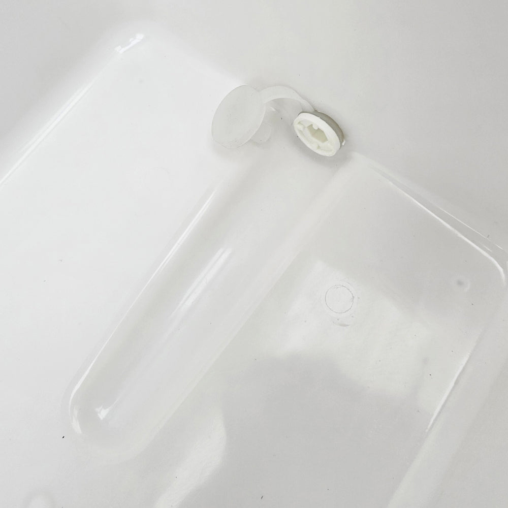 Silicone drain plug can be toggled on and off with manual force.