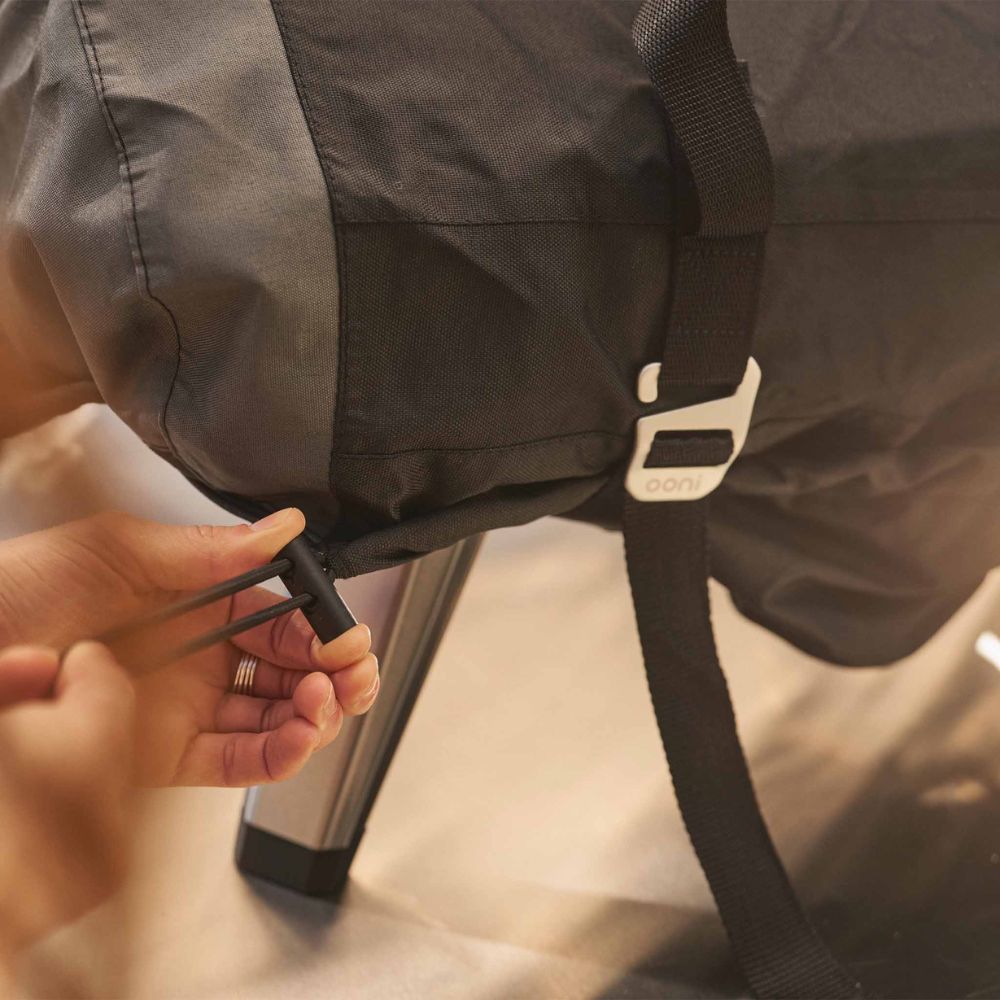 Ooni Koda 2 Black Waterproof Carry Cover with drawstring for a snug fit.