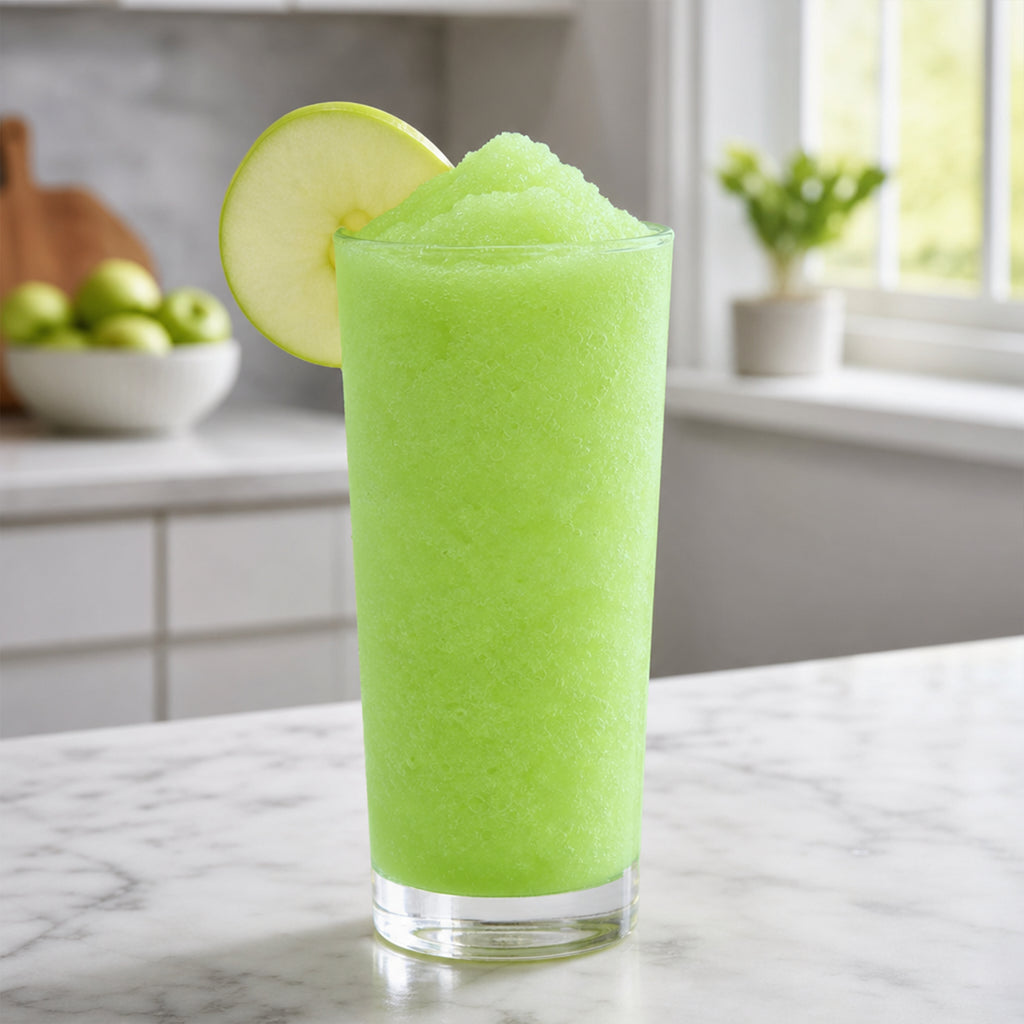 Sour Apple Slushy from VINKA in a high ball glass with a green apple slice garnish.