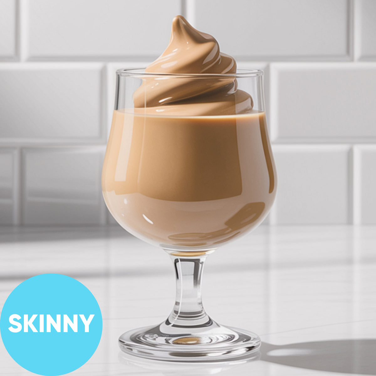 A clear stemmed glass filled with Frozen Skinny Hard Irish Cream VINKA Slushy Kit (2L), set on a white surface against a white subway-tile background. A bright blue circle in the lower left reads “SKINNY.
