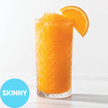 Frozen Skinny Hard Orange Soda VINKA Slushy Kit (2L) in a tall textured clear glass with an orange slice garnish, shown on a white background with a blue circular 'SKINNY' label in the lower left.