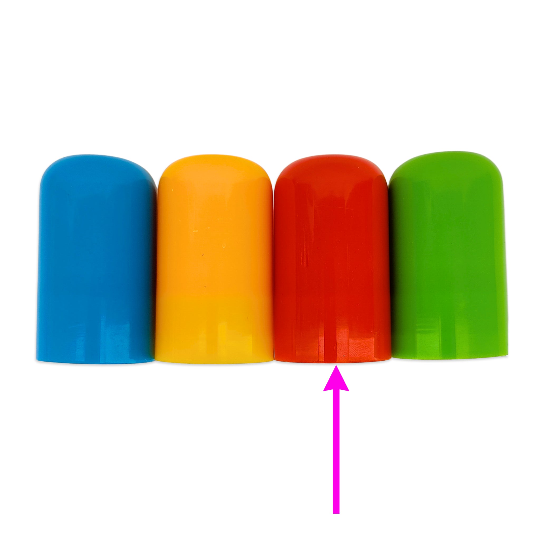 Four colorful cylindrical caps or plugs in blue, yellow, red, and green, arranged in a row on a white background with a pink arrow pointing up at the red one.