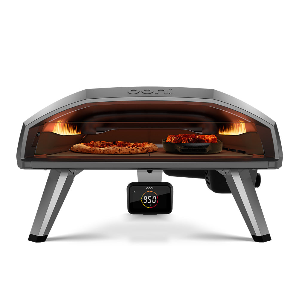 Ooni Koda 2 Pro 18" Gas Powered Pizza Oven Front View with flame, pizza and steak