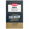 A single packet of LalEmand Abbaye Belgian-Style Ale Yeast from the LalBrew Premium Series. The packaging features a dark navy blue textured background with gold abstract patterns, a white label with red and black text, and a gold-colored bottom section.